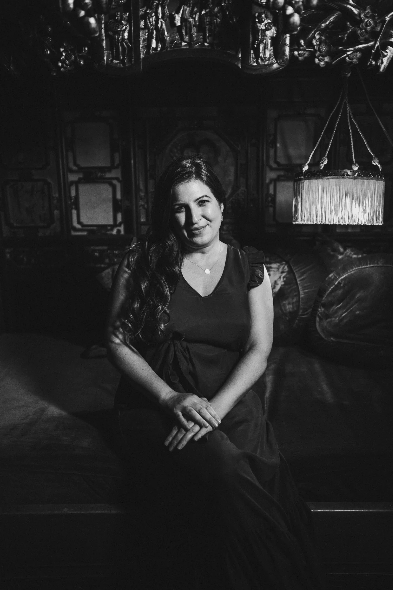 Black-and-white portrait of Parisa seated in an ornate historic interior