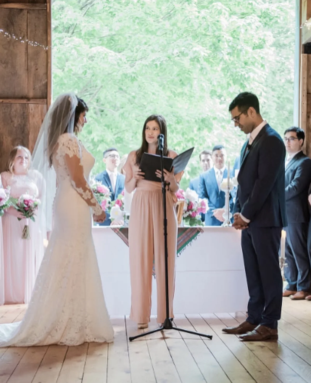 Parisa listening during an outdoor wedding ceremony in Maine