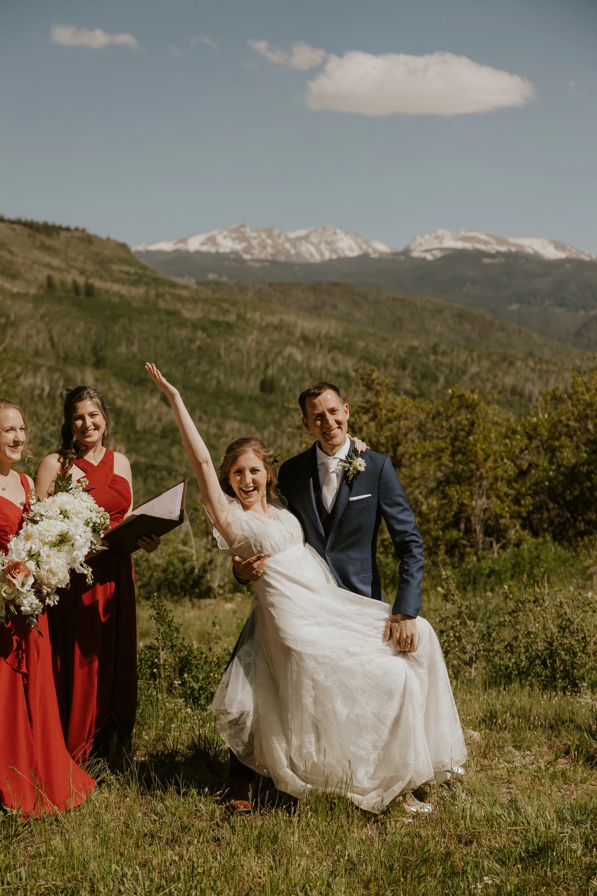 A newly married couple celebrating with Parisa beside them in the Colorado mountains